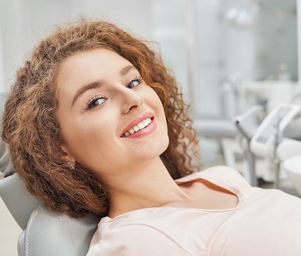 Woman with dental bridge in Wauwatosa, WI leaning back in chair