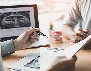 dentist and patient reviewing the cost of cosmetic dental services in Wauwatosa 