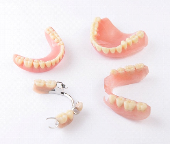 Full and partial dentures against neutral white background