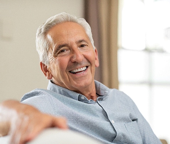 Happy senior man enjoying the benefits of dentures