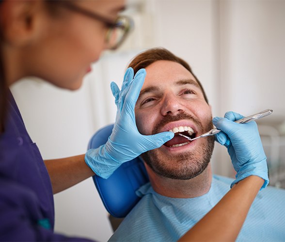 Man receiving checkup to prevent dental emergencies