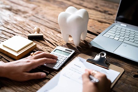 A patient filling out their dental insurance form