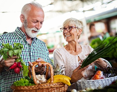 couple picking healthy food for dental implant care in Wauwatosa