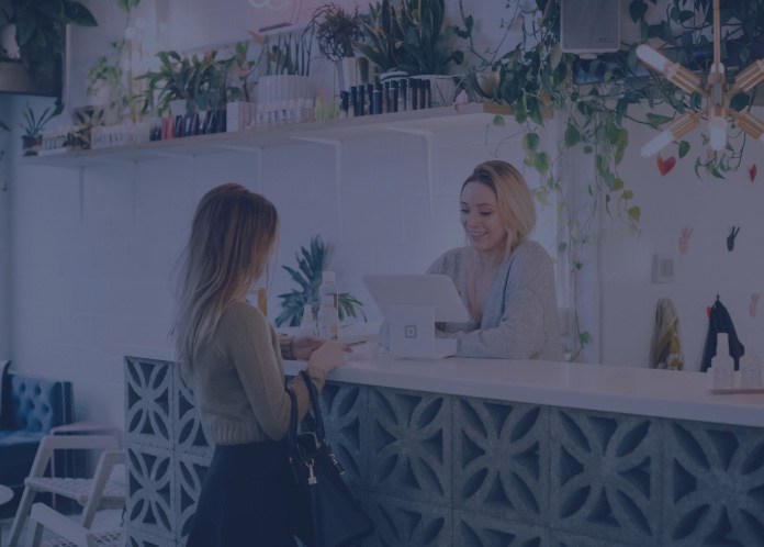 Woman handing in dental insurance forms at reception desk