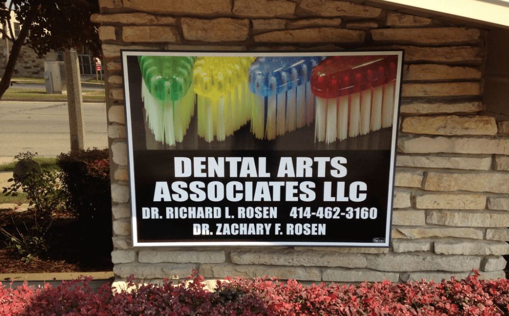 Wauwatosa dental office sign on the side of a building