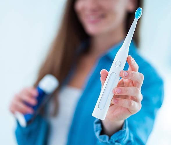 Patient using at home oral hygiene products